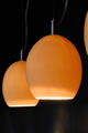 Small pendant fixtures and recessed downlights are effective over a kitchen island. Many pendant fixtures are suspended from a track and can be a fairly simple retrofit. However, pendants should not be suspended so low as to block a person's vision while seated or standing at the counter. These pendant lights are efficient in providing light since concentrated light is directed on the surface.